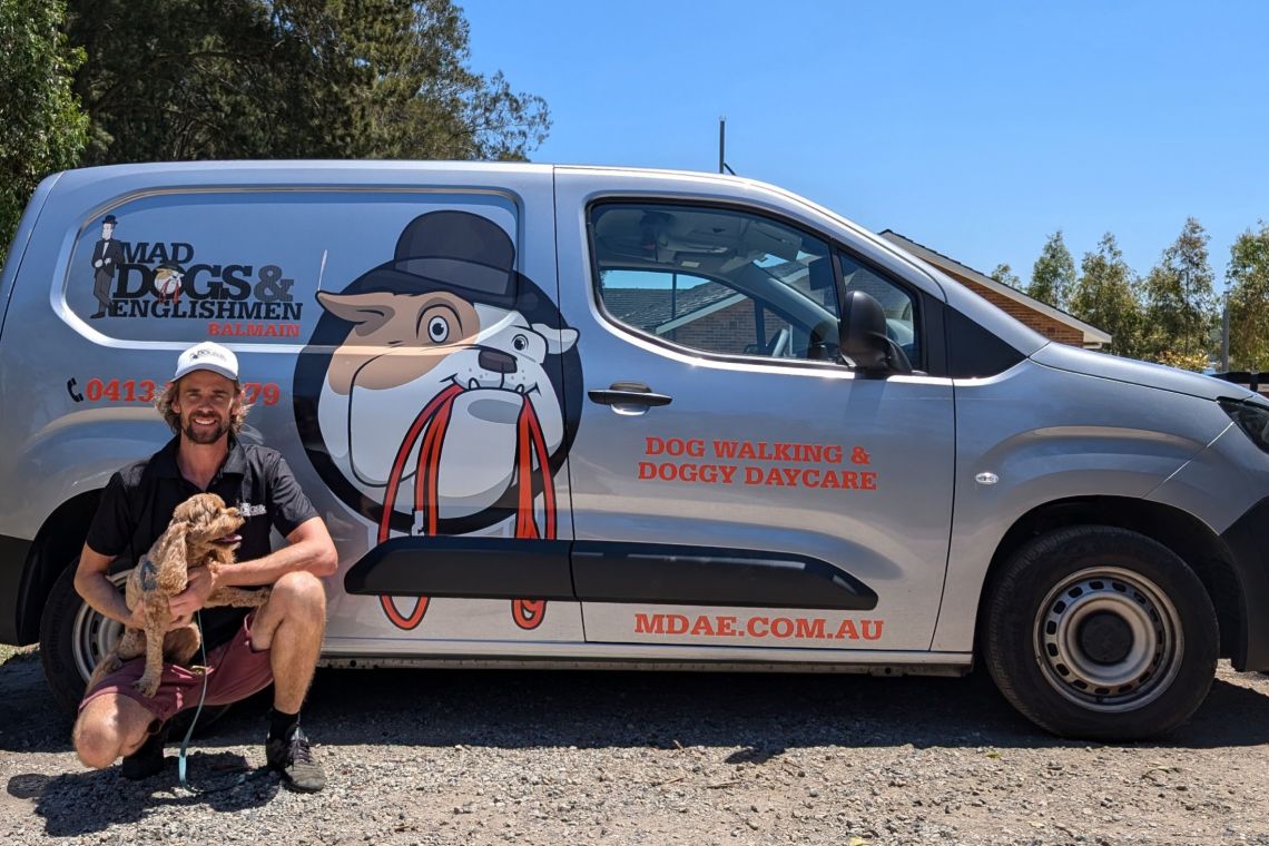 Luke sitting beside his air-conditioned van